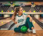 woman-sitting-in-a-bowling-alley-3211236
